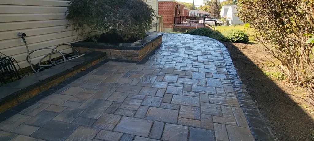 Permeable patios & walkways in Rehoboth, DE, constructed with open-graded aggregate drainage layers compliant with Sussex Conservation District stormwater and lot coverage codes.