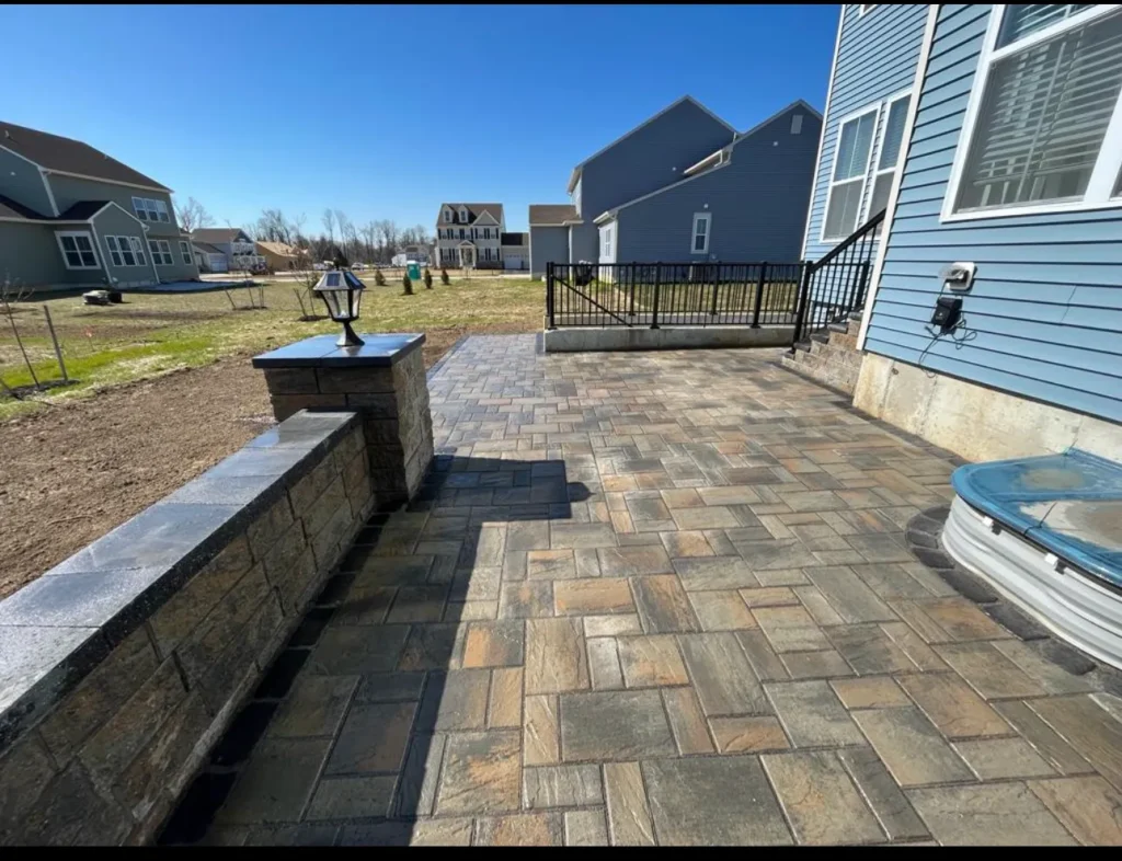 Permeable paver hardscaping in Bethany Beach, DE, engineered with open-graded aggregate drainage layers compliant with Sussex Conservation District coastal lot coverage limits.